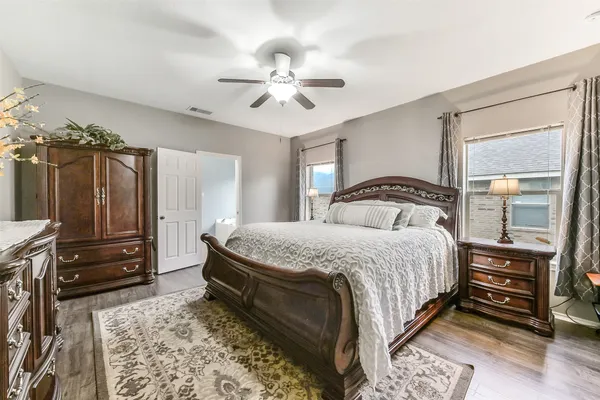 a bedroom with a bed and a chandelier