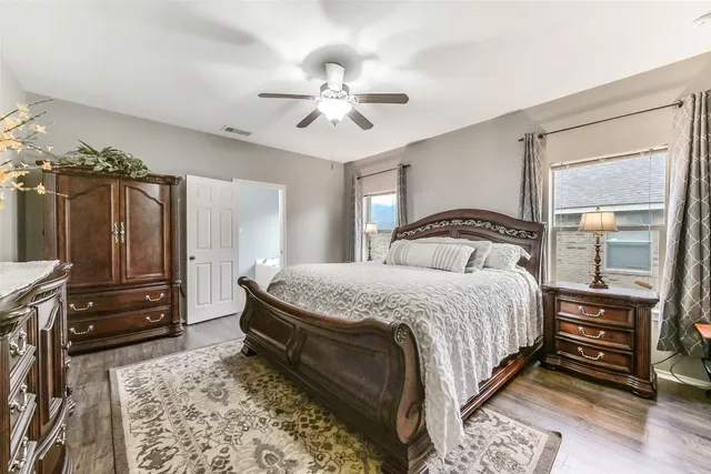 a bedroom with a bed and wooden floor