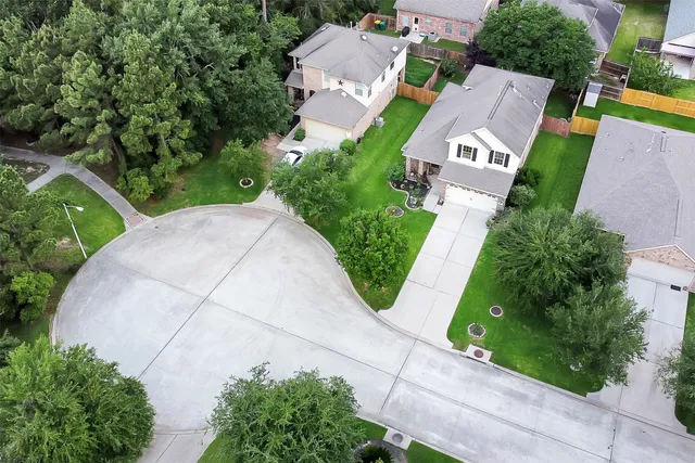 an aerial view of a house with garden space and street view