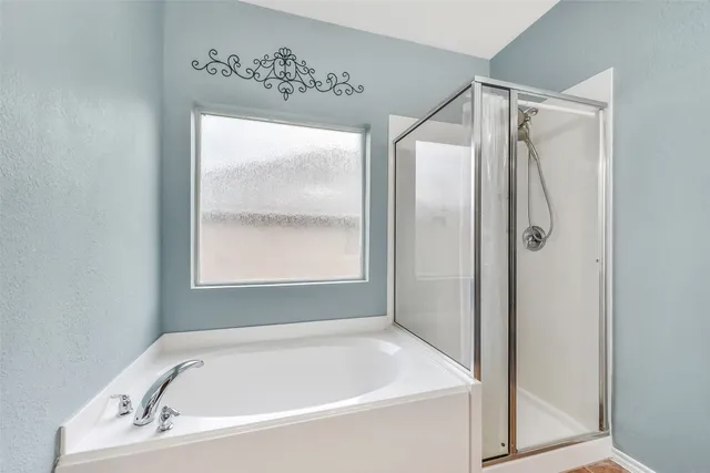 a bathroom with a tub and shower