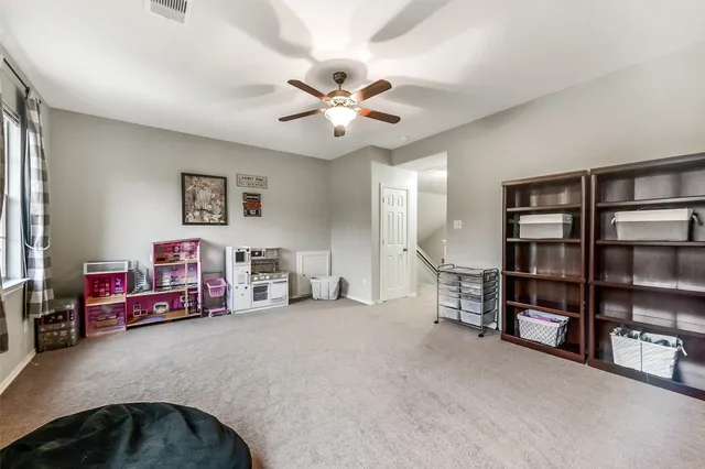 a view of a livingroom with furniture and staircase