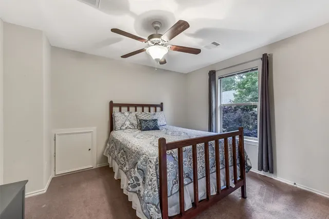a bedroom with a bed and window