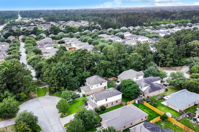 an aerial view of residential houses with outdoor space