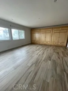 a kitchen with stainless steel appliances granite countertop a kitchen island a hardwood floor and a sink