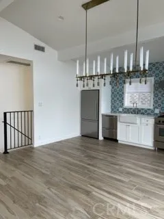 a kitchen with granite countertop a sink stove and cabinets