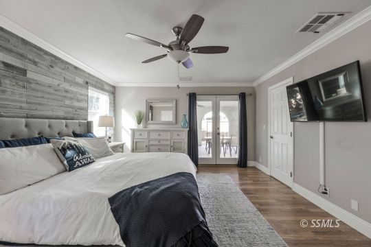 1113 Amie Court Ridgecrest, CA 93555 - Photo 24 of 33 a spacious bedroom with a large bed and a chandelier