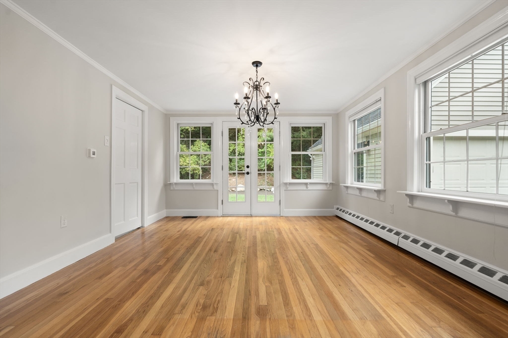 92 Abbot Street Andover, MA 01810 - Photo 17 of 35 a view of an empty room with a window and wooden floor