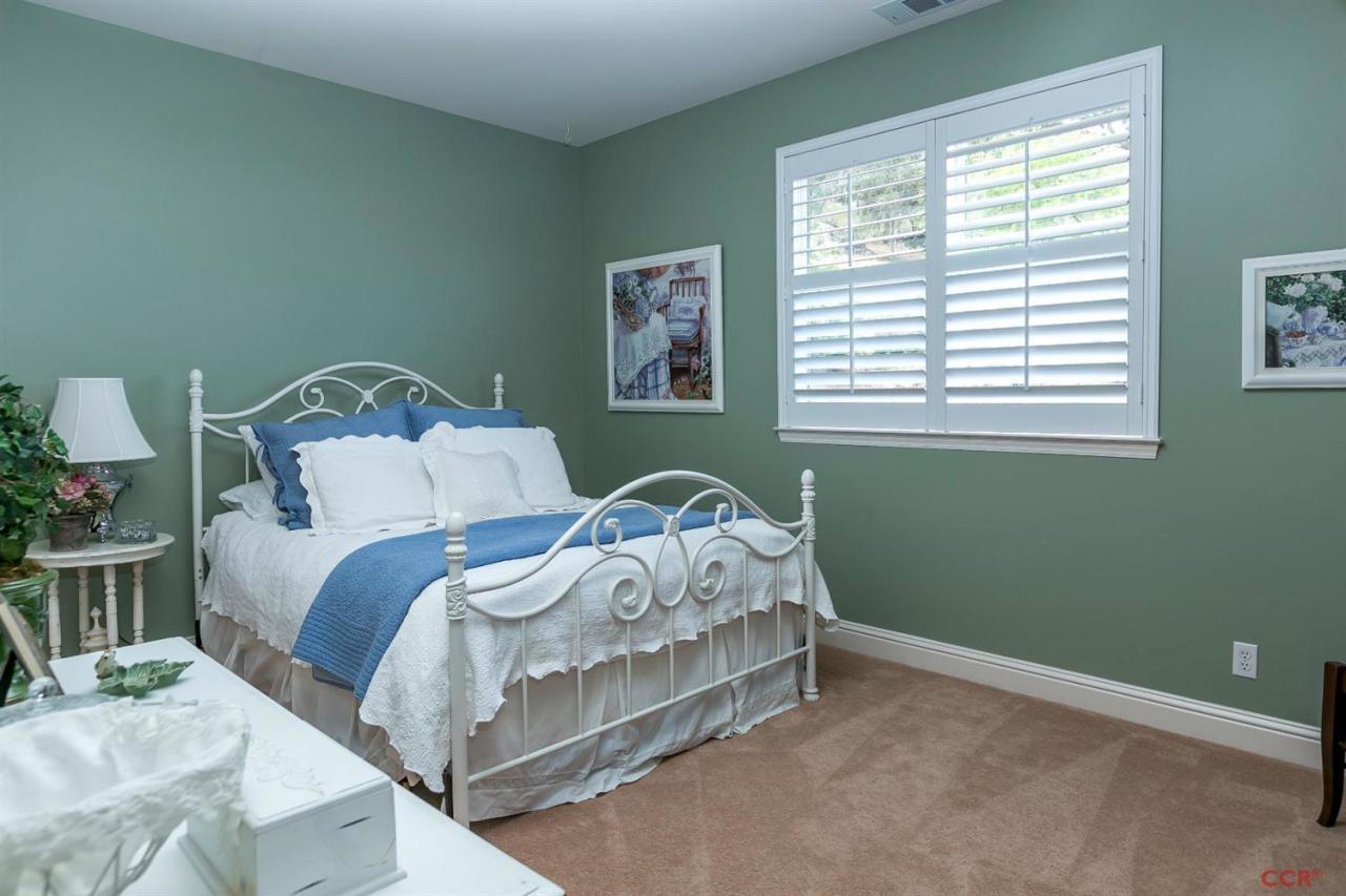 6300 San Gabriel Road Atascadero, CA 93422 - Photo 12 of 25 a bed sitting in a bedroom next to a window