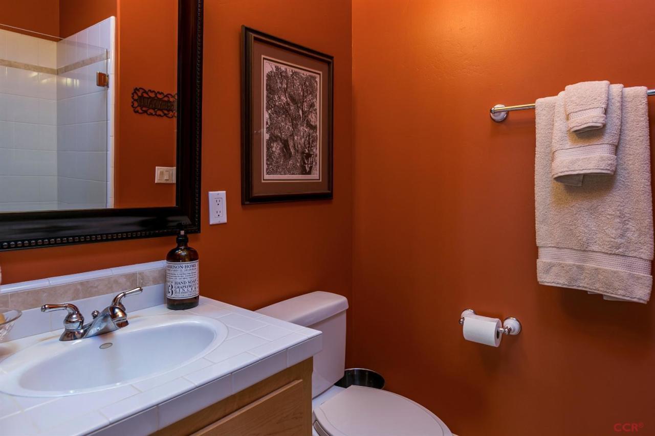 6300 San Gabriel Road Atascadero, CA 93422 - Photo 16 of 25 a bathroom with a sink mirror and toilet