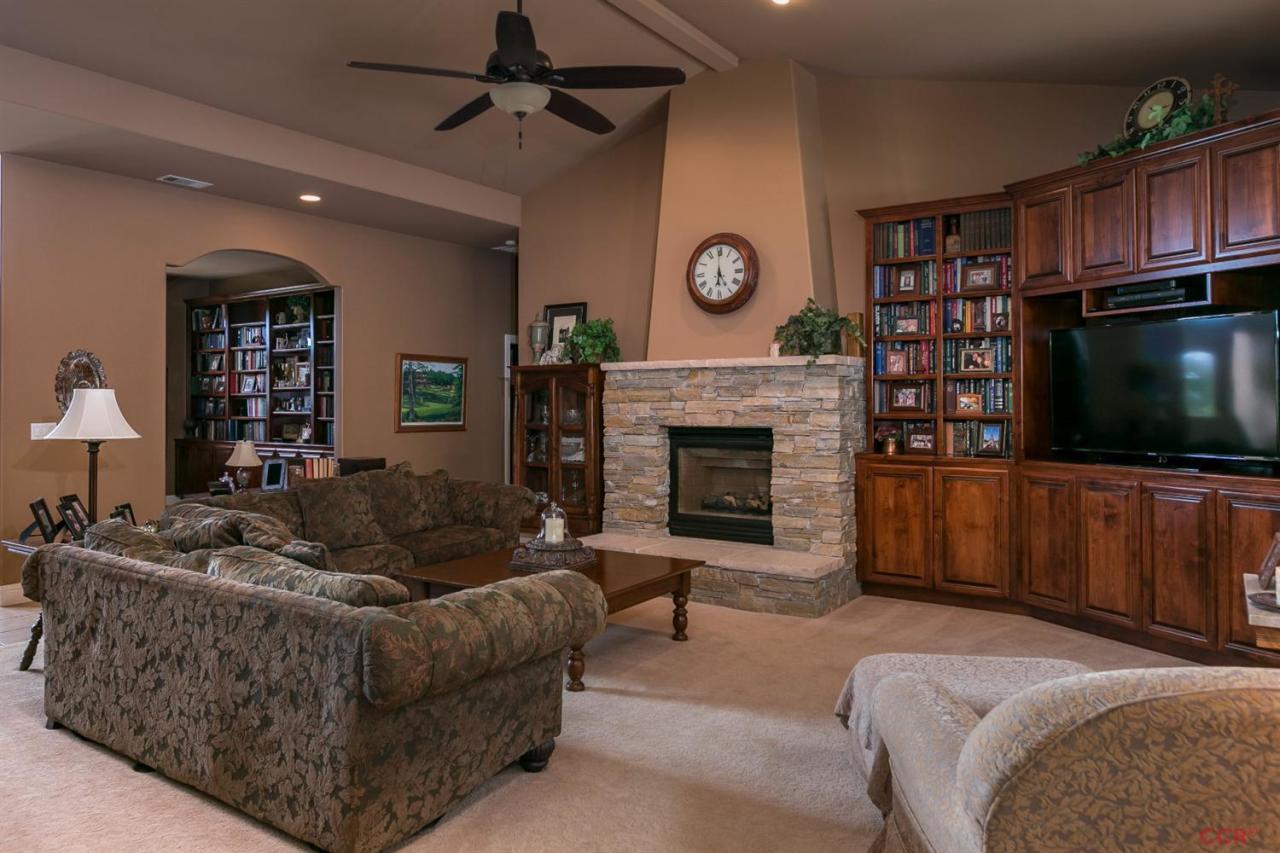 6300 San Gabriel Road Atascadero, CA 93422 - Photo 7 of 25 a living room with furniture a flat screen tv and a fireplace