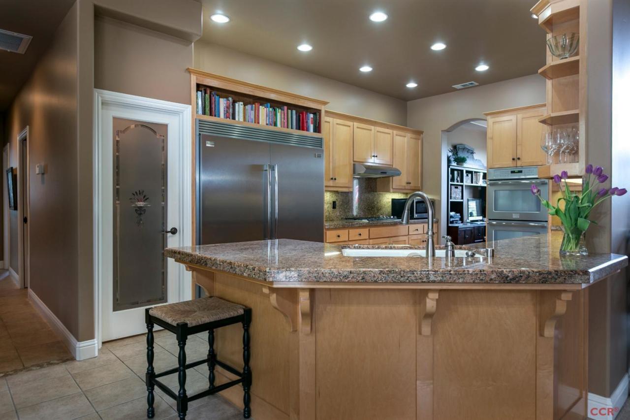 6300 San Gabriel Road Atascadero, CA 93422 - Photo 8 of 25 a kitchen with kitchen island granite countertop a refrigerator and a sink