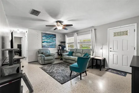 a living room with furniture and a chandelier