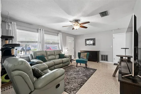 a living room with furniture a couch and a flat screen tv