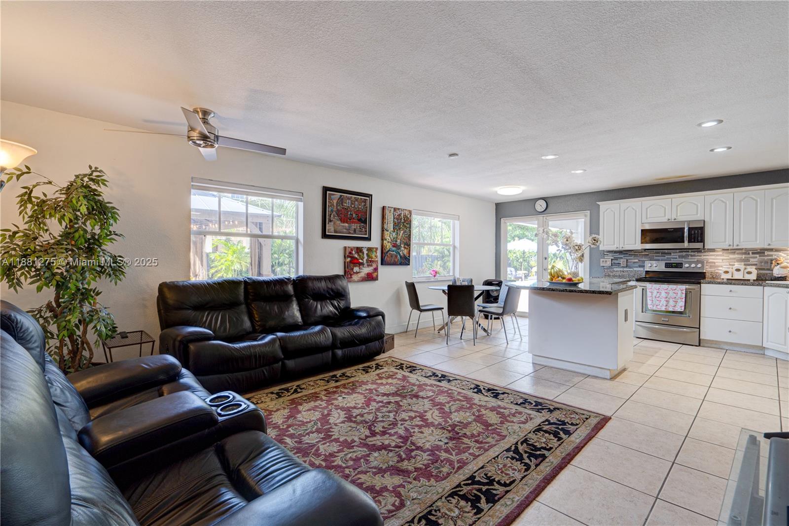 15750 Southwest 45th Street Miami, FL 33185 - Photo 13 of 45 a living room with furniture and a dining room with kitchen view
