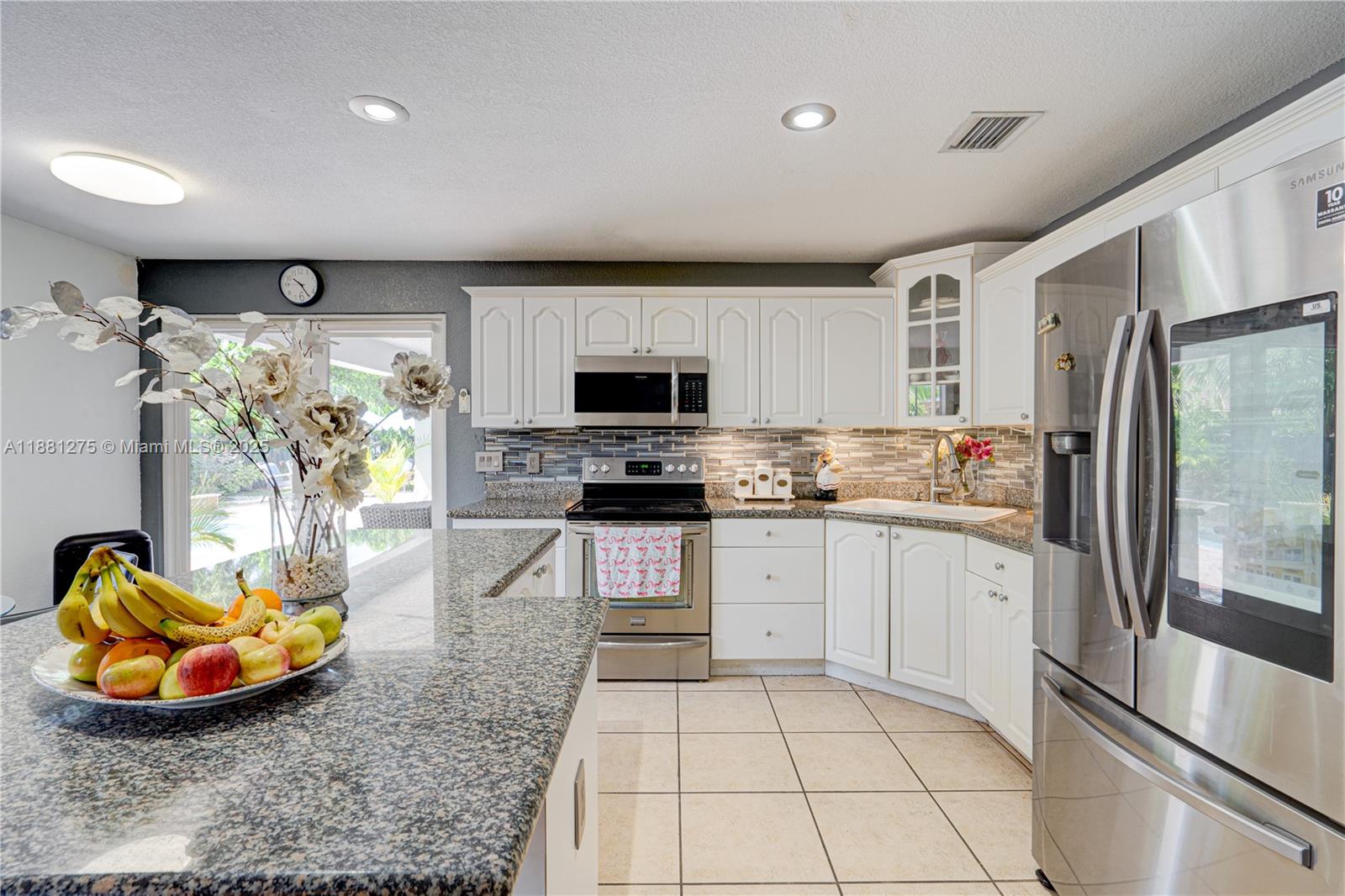 15750 Southwest 45th Street Miami, FL 33185 - Photo 14 of 45 a kitchen with stainless steel appliances granite countertop a refrigerator sink and stove