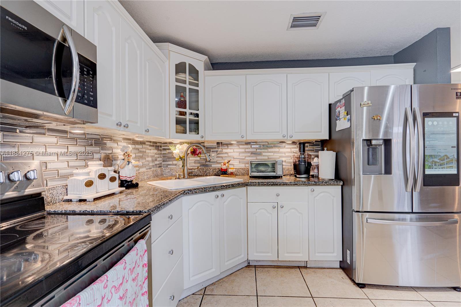 15750 Southwest 45th Street Miami, FL 33185 - Photo 15 of 45 a kitchen with stainless steel appliances granite countertop a refrigerator sink and stove
