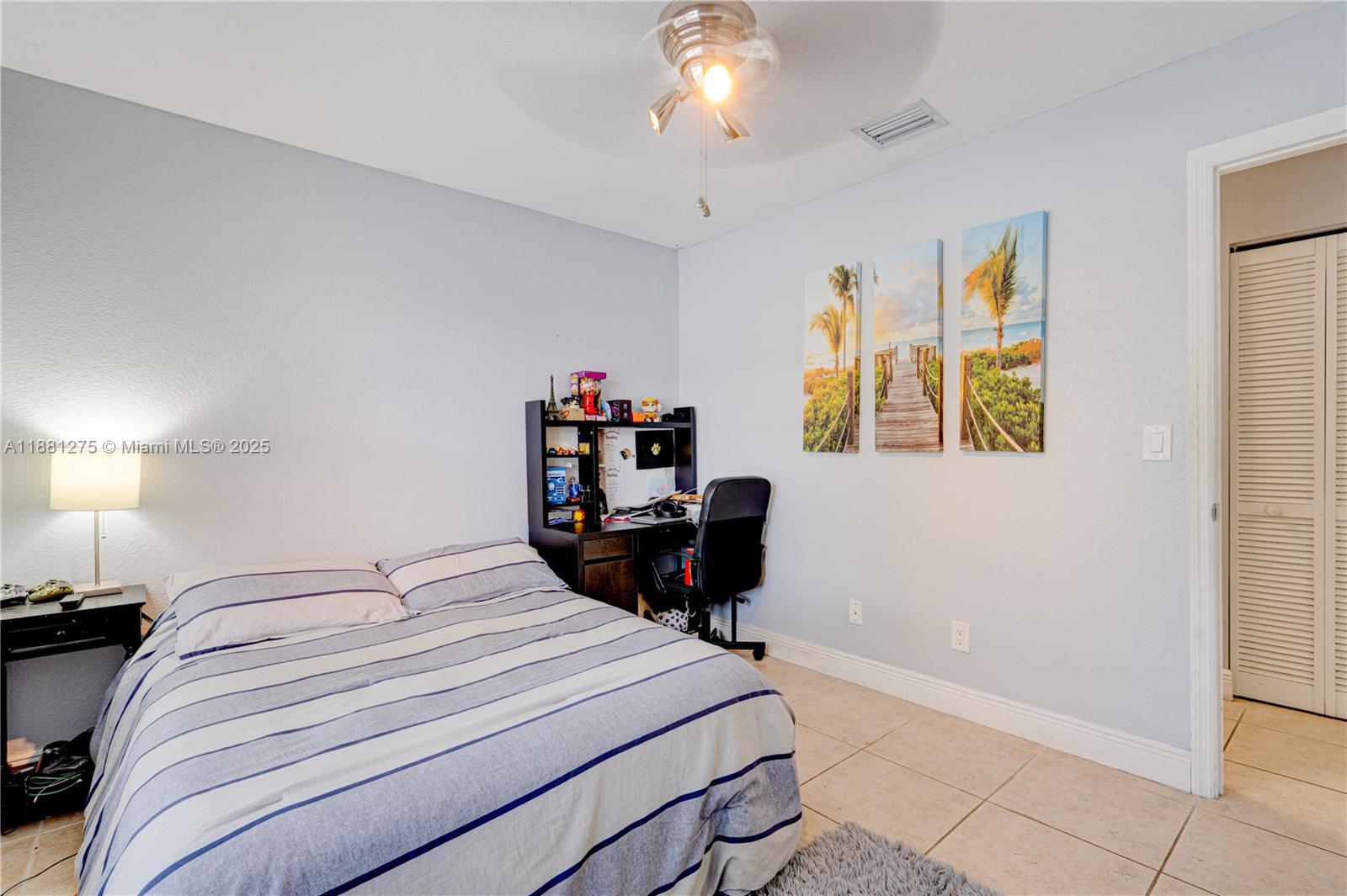 15750 Southwest 45th Street Miami, FL 33185 - Photo 20 of 45 a bedroom with a bed and a chandelier