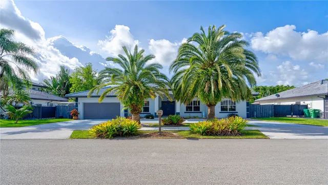 a couple of palm trees in front of house