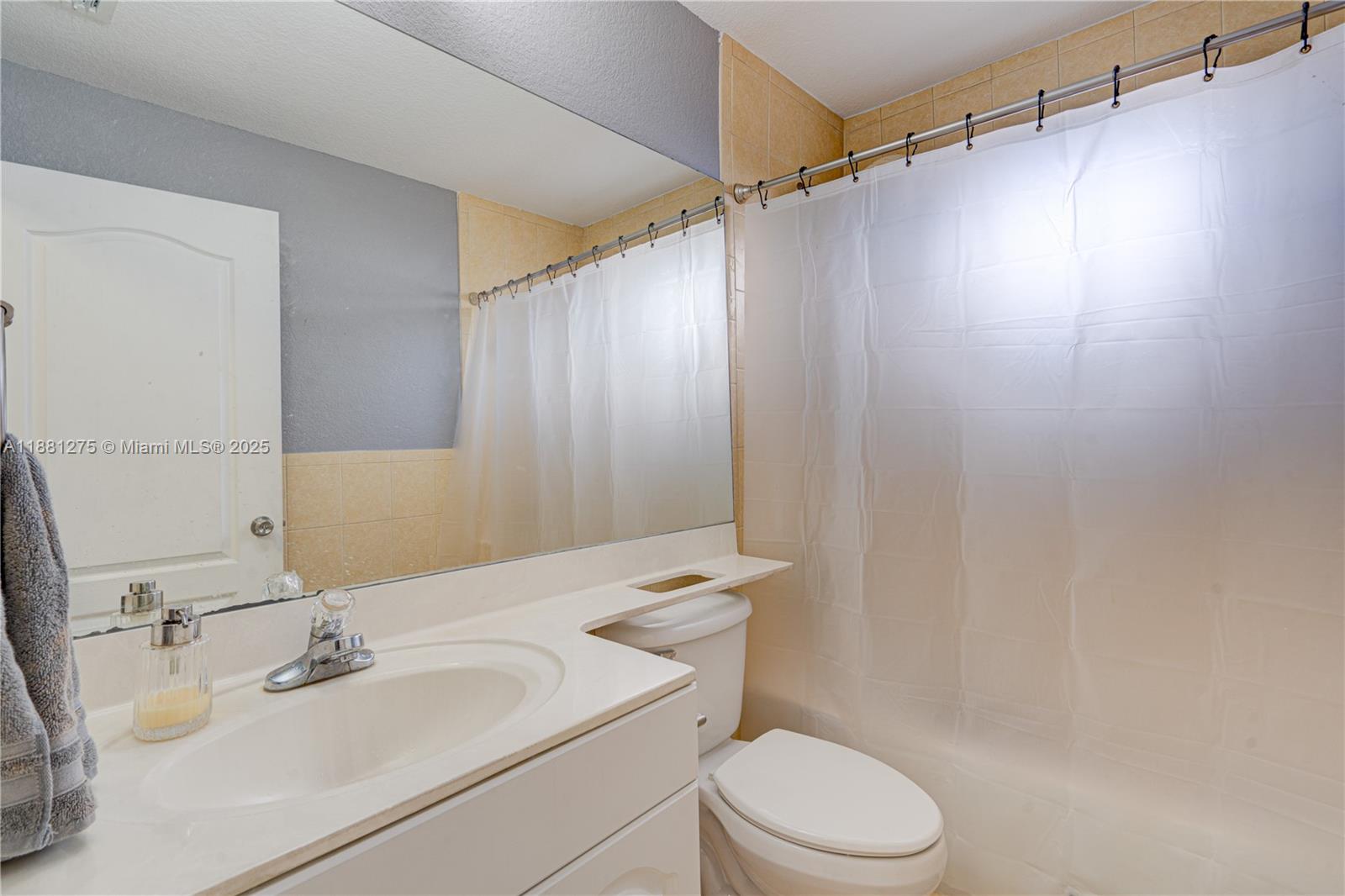 15750 Southwest 45th Street Miami, FL 33185 - Photo 22 of 45 a bathroom with a sink vanity mirror and toilet