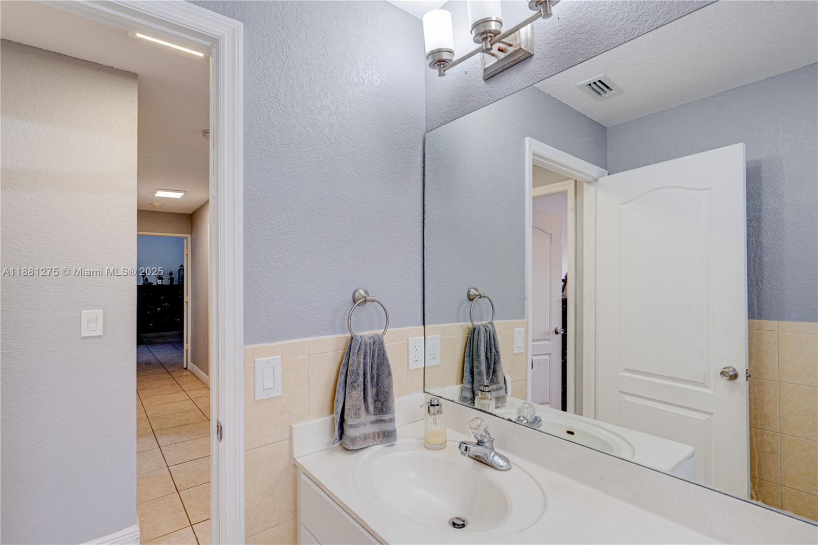 15750 Southwest 45th Street Miami, FL 33185 - Photo 23 of 45 a bathroom with a sink and a mirror