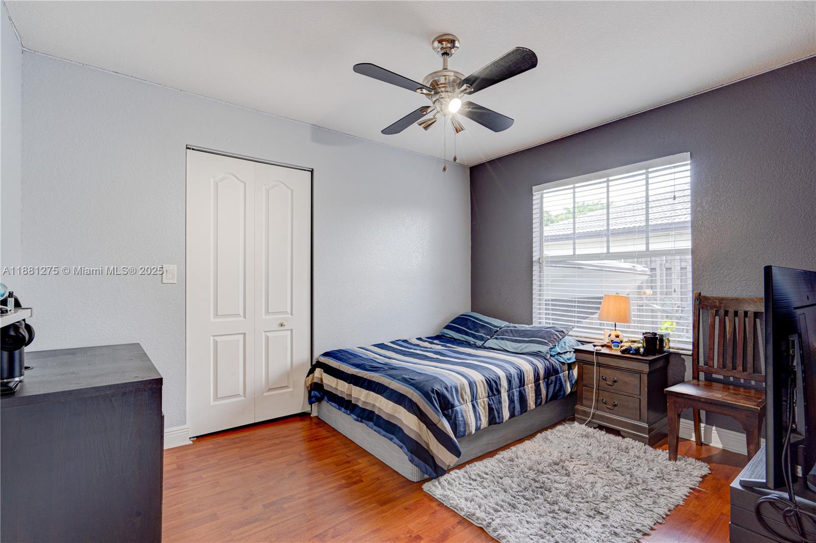 15750 Southwest 45th Street Miami, FL 33185 - Photo 24 of 45 a bedroom with a bed and a chandelier