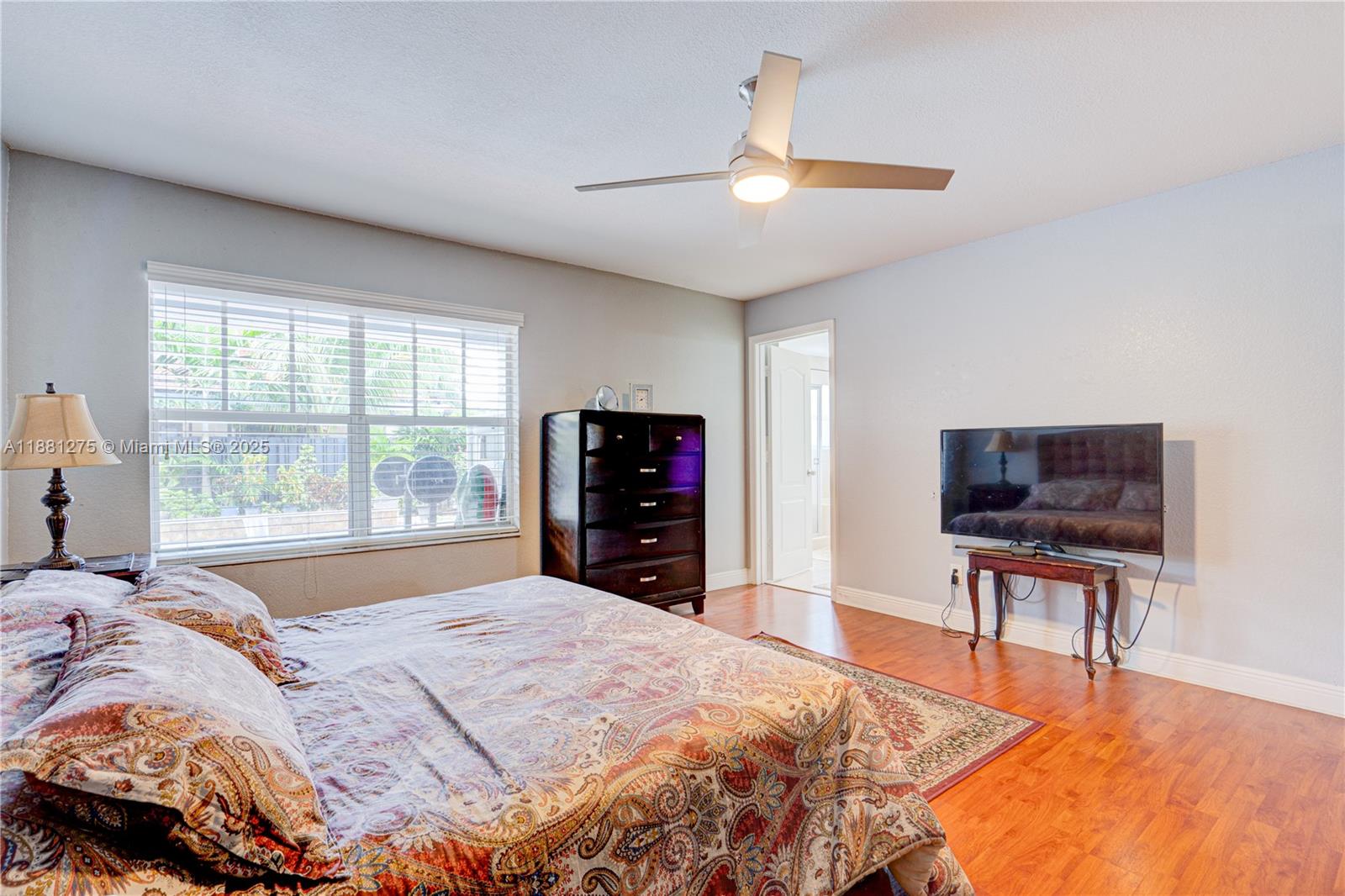 15750 Southwest 45th Street Miami, FL 33185 - Photo 28 of 45 a bedroom with a bed and a television