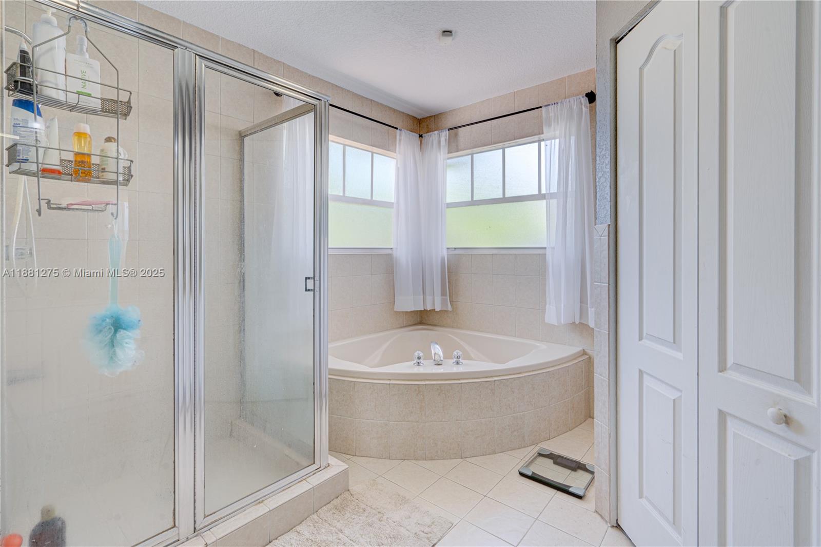 15750 Southwest 45th Street Miami, FL 33185 - Photo 30 of 45 a bathroom with a tub a window and a shower