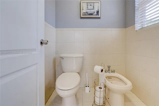 a white toilet sitting next to a bathroom sink