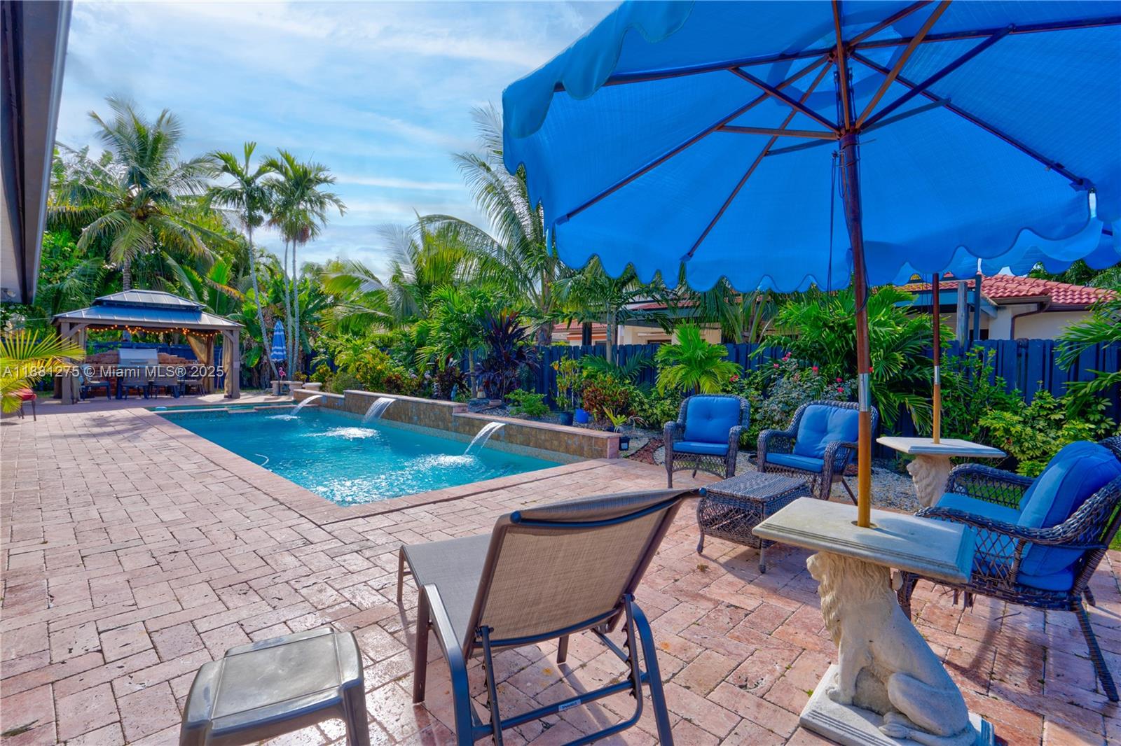 15750 Southwest 45th Street Miami, FL 33185 - Photo 39 of 45 a view of a chairs and table under an umbrella