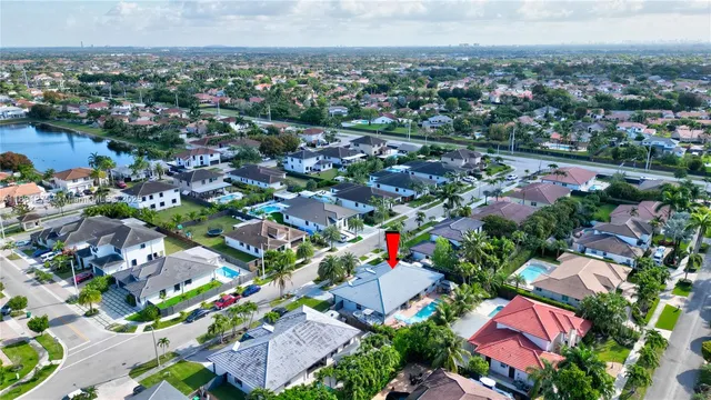 an aerial view of a house with garden space and trees in front of it
