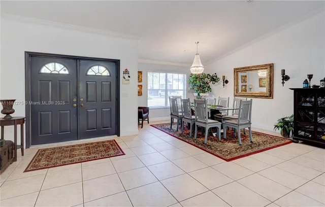 a living room with furniture a dining table and a chandelier