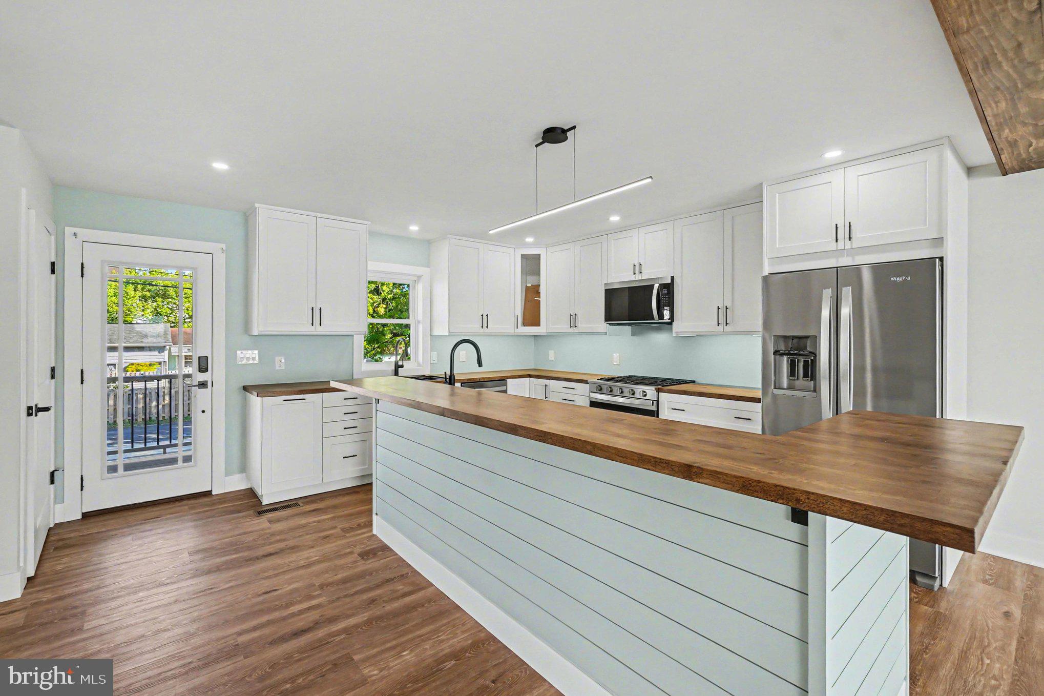 9108 Hinton Avenue Sparrows Point, MD 21219 - Photo 21 of 86 a large kitchen with kitchen island a sink stainless steel appliances and cabinets