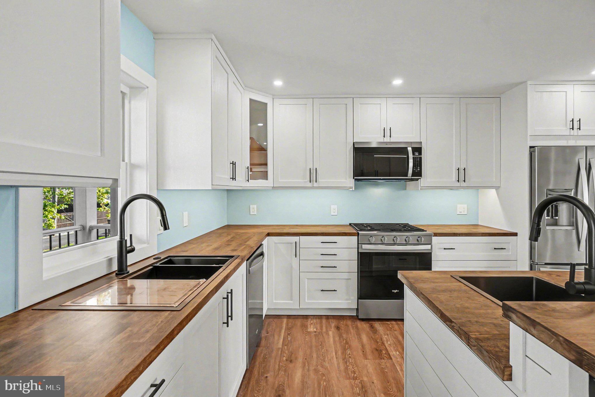 9108 Hinton Avenue Sparrows Point, MD 21219 - Photo 23 of 86 a kitchen with stainless steel appliances granite countertop a sink a stove top oven a counter space and cabinets