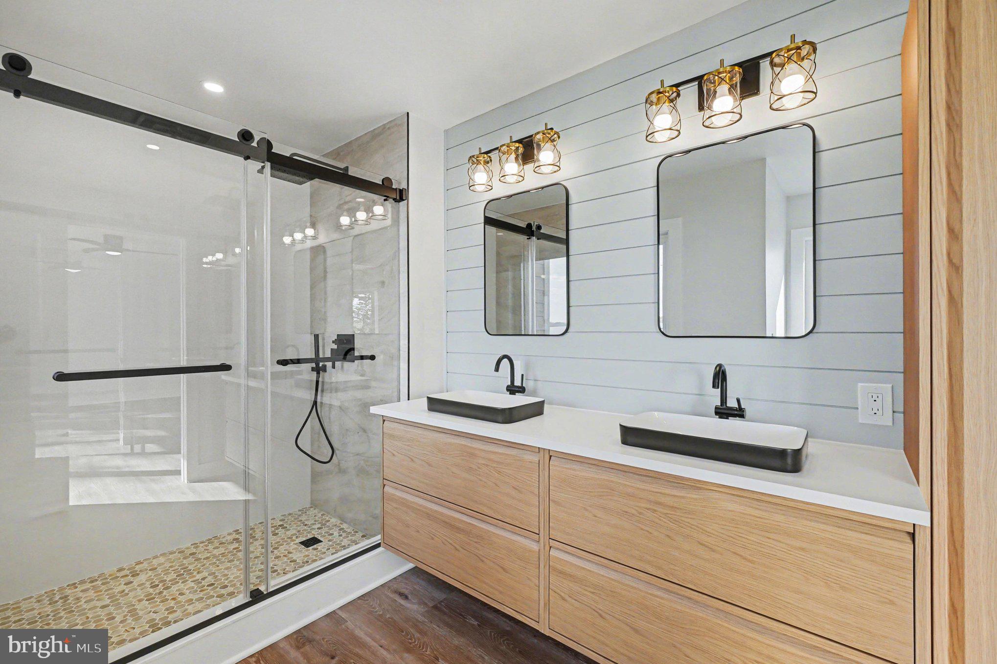 9108 Hinton Avenue Sparrows Point, MD 21219 - Photo 38 of 86 a bathroom with a double vanity sink mirror and shower