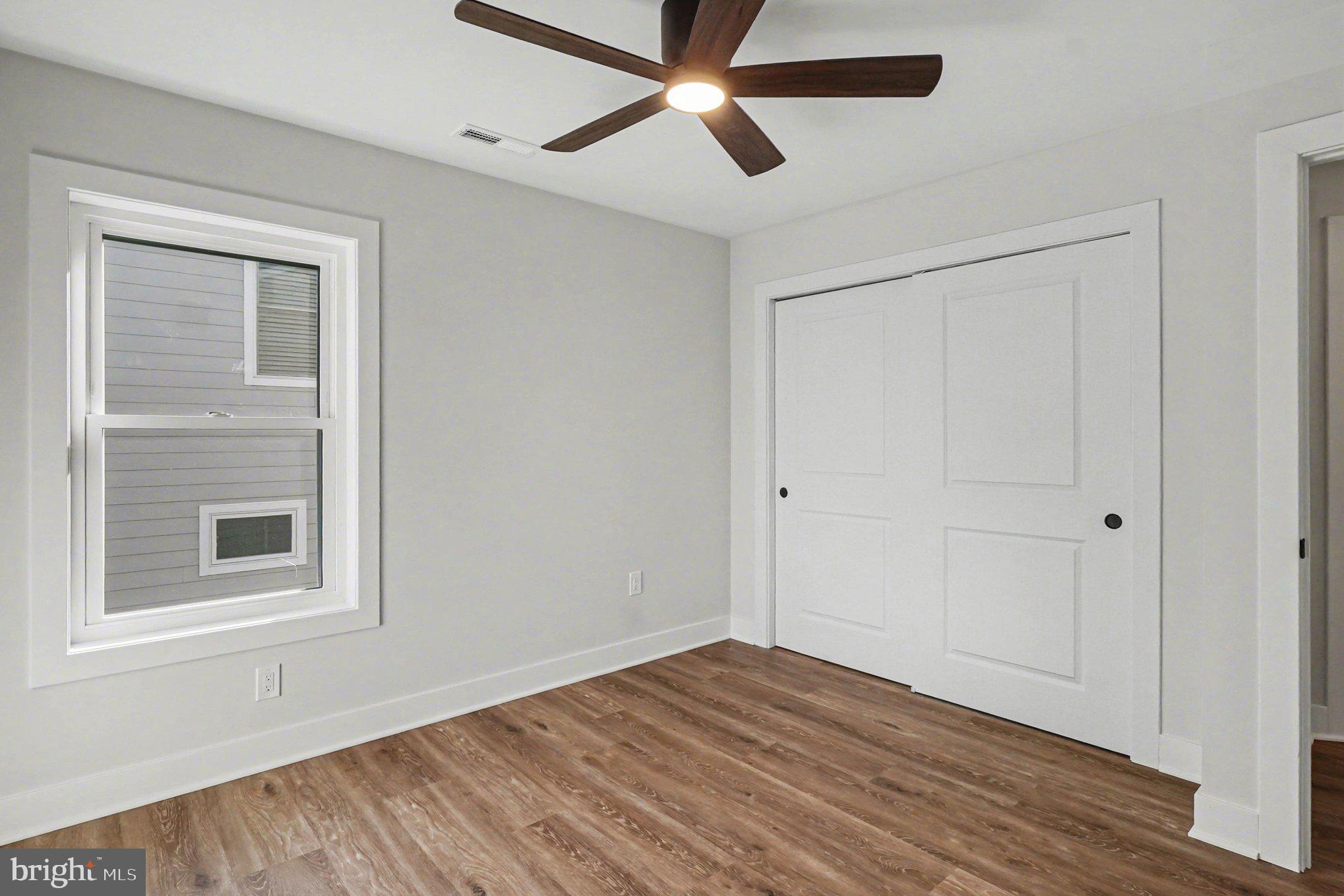 9108 Hinton Avenue Sparrows Point, MD 21219 - Photo 41 of 86 a view of empty room with wooden floor and fan