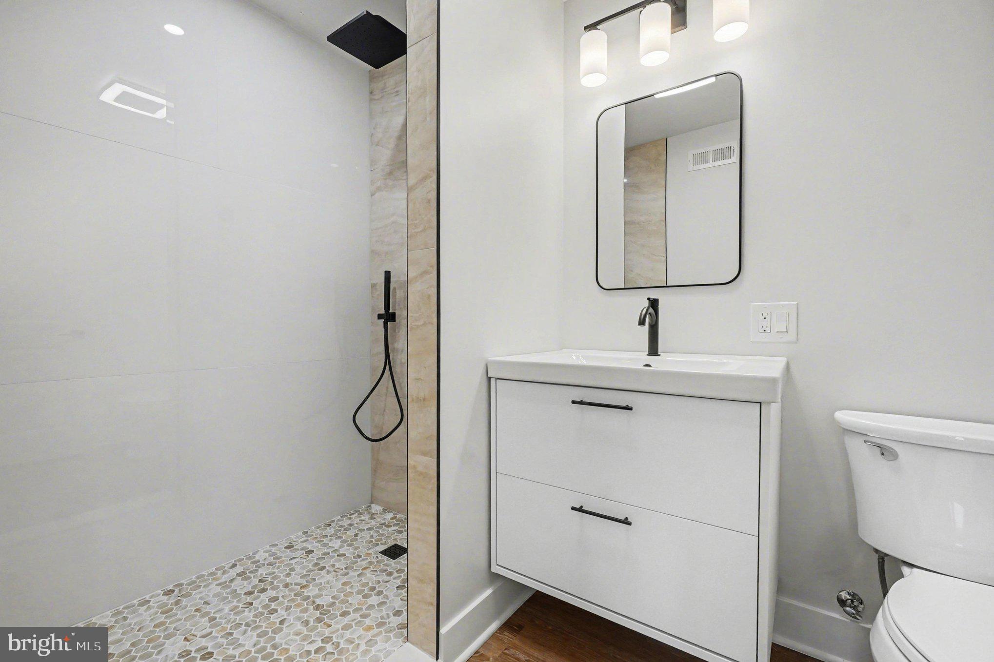 9108 Hinton Avenue Sparrows Point, MD 21219 - Photo 52 of 86 a bathroom with a toilet sink and mirror