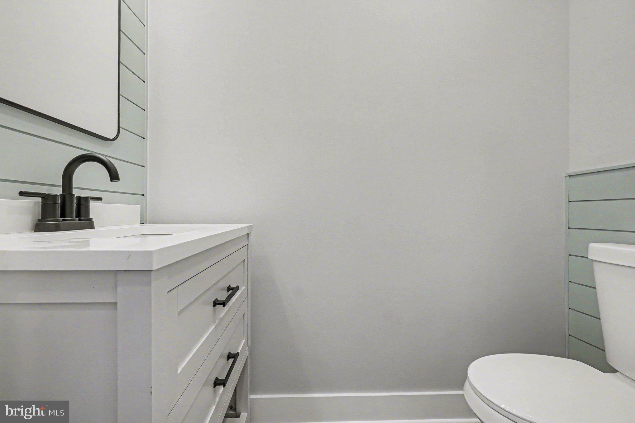 9108 Hinton Avenue Sparrows Point, MD 21219 - Photo 53 of 86 a bathroom with a sink a toilet and vanity