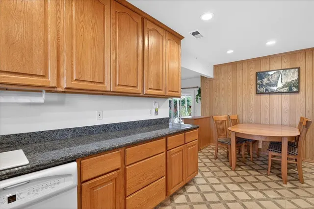 a kitchen with stainless steel appliances granite countertop a sink and cabinets
