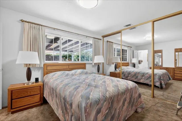 a bedroom with a large bed and a window