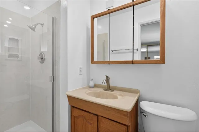 a bathroom with a toilet sink and mirror