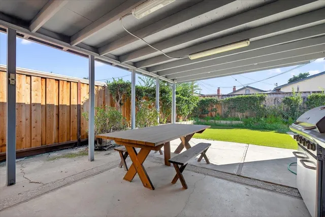 a view of swimming pool with a patio and a yard