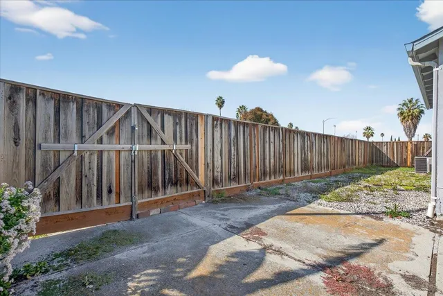 a view of backyard with wooden fence