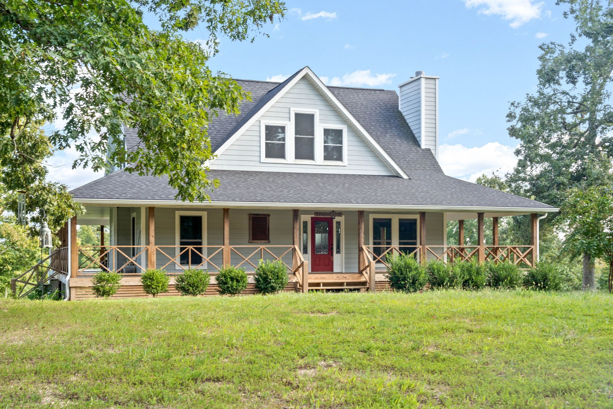 a front view of house with yard and green space