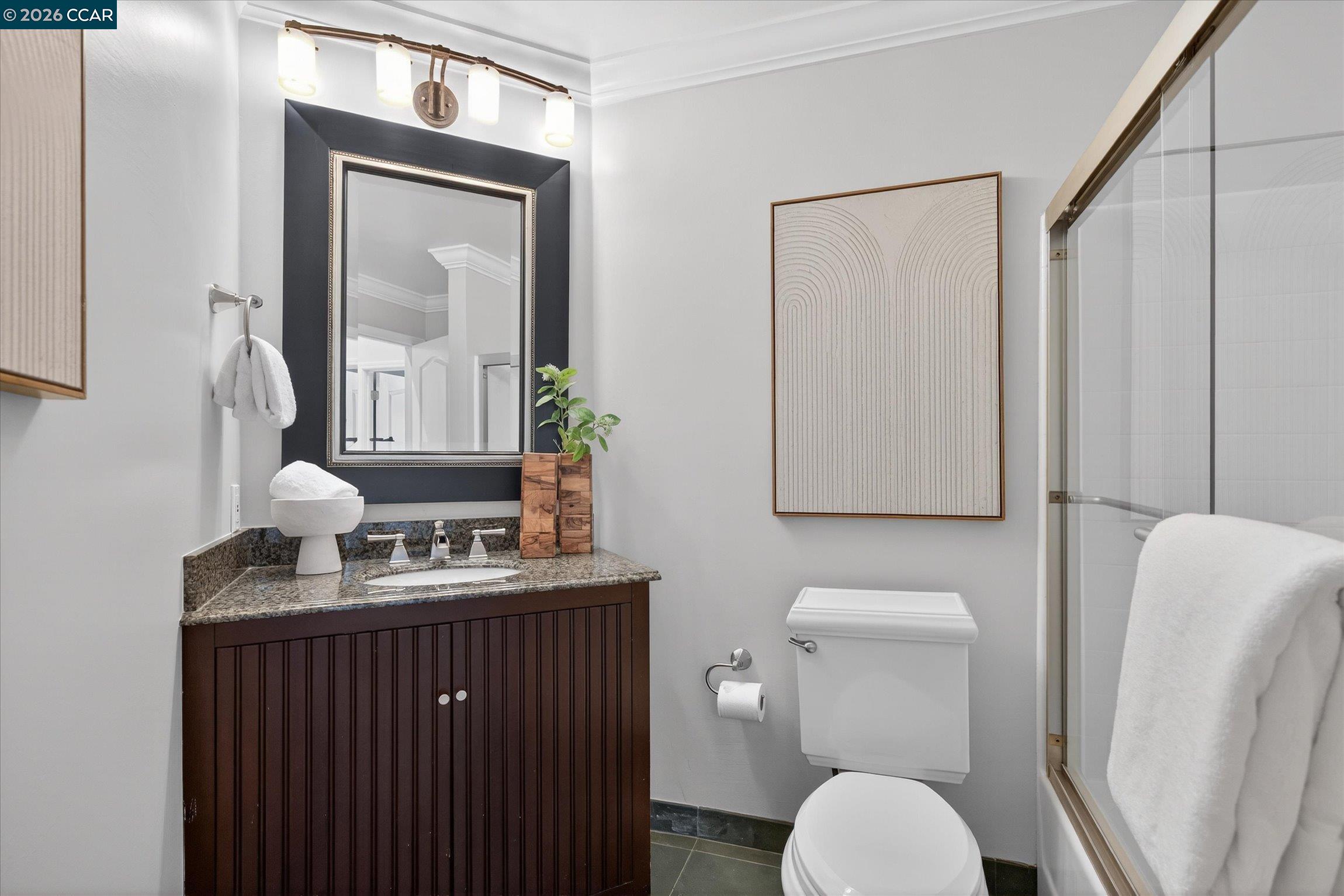 4059 West Lakeshore Drive San Ramon, CA 94582 - Photo 21 of 45 a bathroom with a toilet sink vanity and mirror
