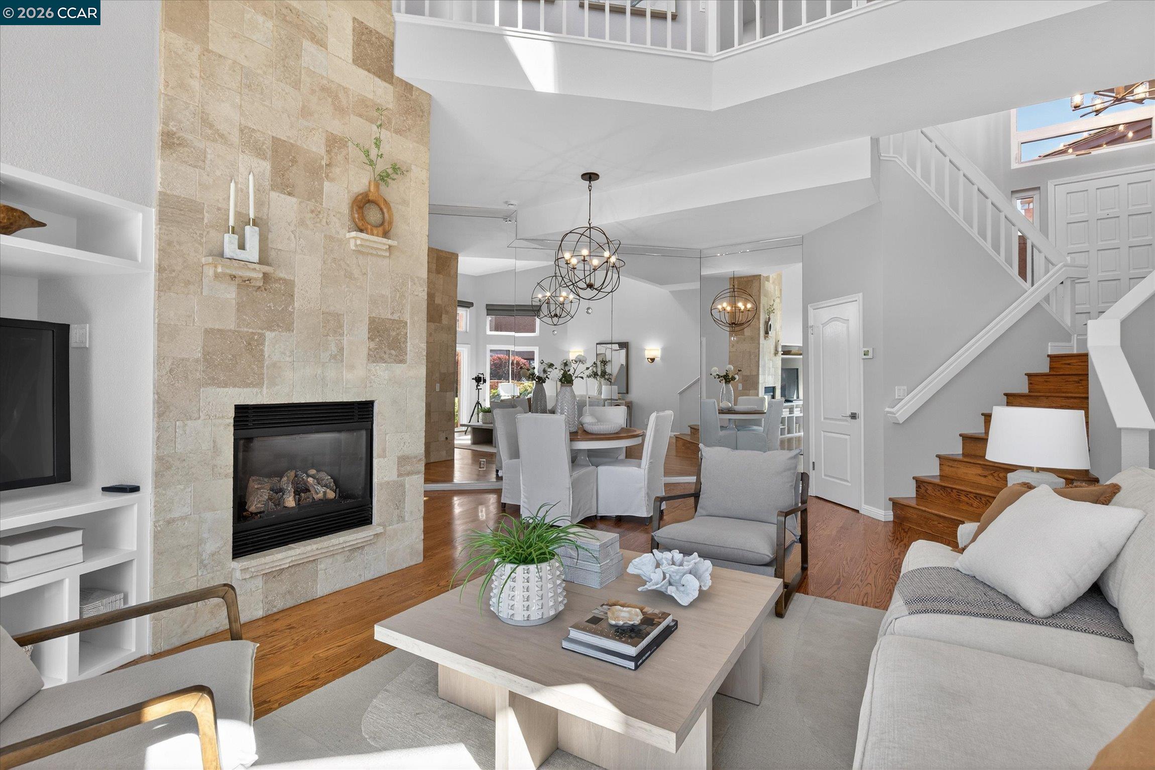 4059 West Lakeshore Drive San Ramon, CA 94582 - Photo 9 of 45 a living room with furniture a fireplace and a chandelier