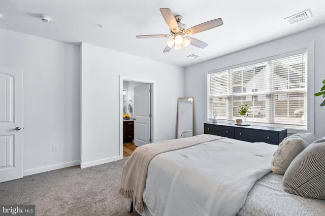 a bedroom with a large bed and a large window