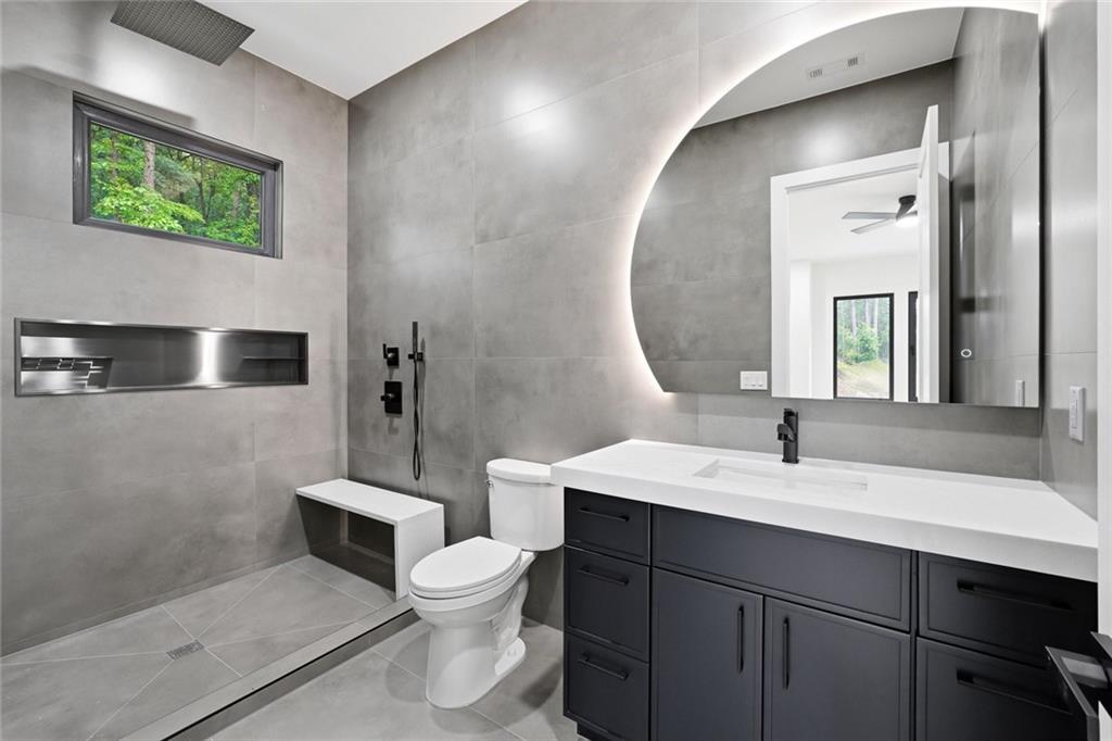 1563 Whitley Road Dacula, GA 30019 - Photo 31 of 44 a bathroom with a toilet sink and mirror