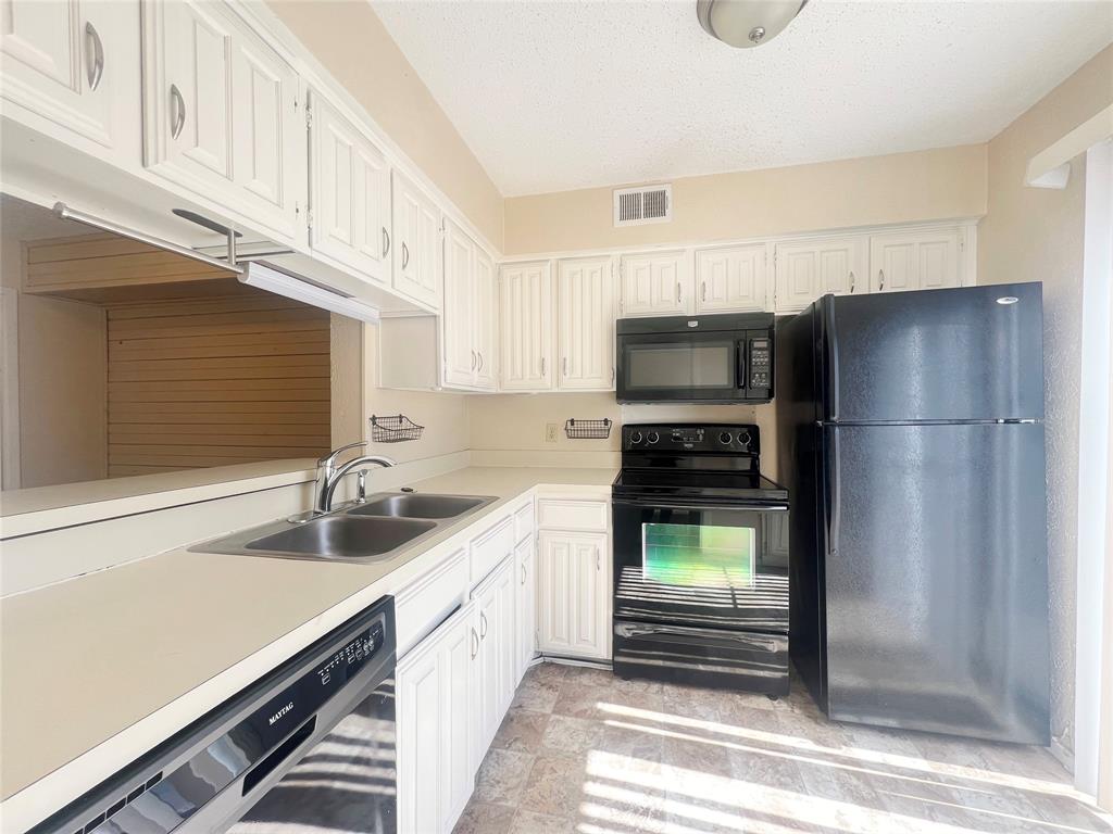 5626 Preston Oaks Road, Unit 43D Dallas, TX 75254 - Photo 3 of 9 a kitchen with a refrigerator and a sink