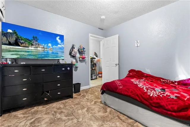 a bedroom with a bed and a dresser