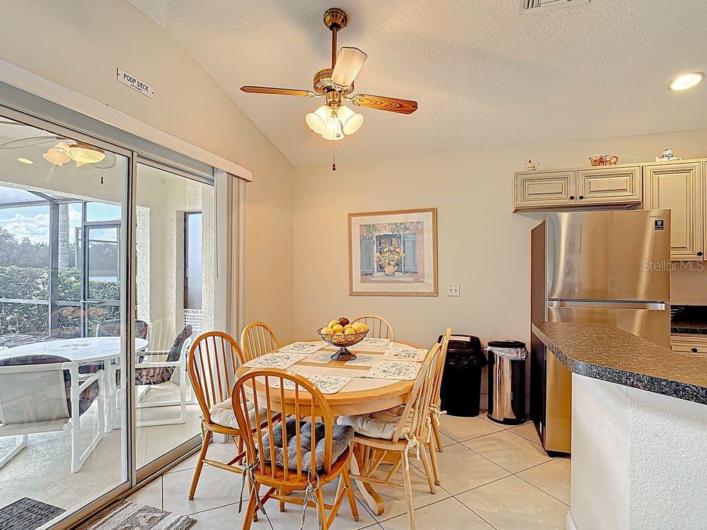 955 Lake Berkley Drive Kissimmee, FL 34746 - Photo 15 of 57 a view of a dining room with furniture large window and chandelier